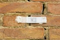 Plastic mechanical crack meter designed to measure movement across surface cracks and joints in an old brick wall cause due to