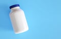 Plastic medicine bottle on blue background Royalty Free Stock Photo