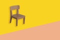 Plastic model of a brown chair on a yellow background, workplace, concept of the daily routine of a freelancer, programmer,