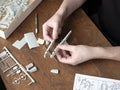 Plastic model builder is slapping a model together. Assembling the model of airplane Royalty Free Stock Photo