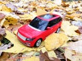 Plastic model car on the yellow autumn leaves Royalty Free Stock Photo