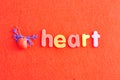 A plastic model of a human heart with the word heart