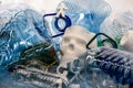 Plastic models of people and skull lying in a pile of plastic garbage