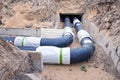 Plastic modern black heating pipes in trench near city house