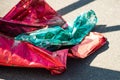 Plastic multicolored balloon lying on asphalt