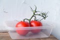 Plastic packaging container with tomatoes