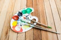 Plastic paint palette with paint and brushes