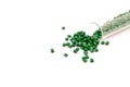 Plastic pallets . Plastic raw materials in granules for industry. Polymeric dye is green on a white background.