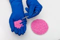Plastic pellets . Colorant for polymers in granules. Plastic pellets in the hands with gloves and tweezers Royalty Free Stock Photo