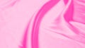 Plastic pink satin fabric texture soft blur background Royalty Free Stock Photo