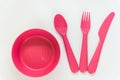 Pink spoon, fork, knife and plate on the white background Royalty Free Stock Photo