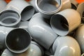 Plastic pipe bends in a pile. Industrial products for construction Royalty Free Stock Photo