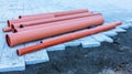 Side view of plastic orange pipes at a construction site Royalty Free Stock Photo