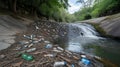 Plastic pollution chokes a river with a small waterfall in the background Royalty Free Stock Photo