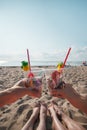 Plastic pollution in ocean environmental problem, girls hands holding plastic cups with straws and cocktail from beach garbage - Royalty Free Stock Photo