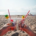 Plastic pollution in ocean environmental problem, hands holding plastic cups with straws and cocktail from beach garbage - Royalty Free Stock Photo