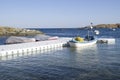 Plastic pontoon with two covered boats and fishing boat Royalty Free Stock Photo