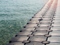 Plastic pontoon walk way floating in the sea Royalty Free Stock Photo