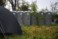 Plastic portable toilets on a camping site at a music festival