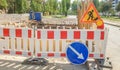 Plastic Protective barrier fences the site of road work. Red and white plastic fence near the street repair site. Construction Royalty Free Stock Photo