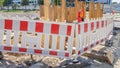 Plastic Protective barrier fences the site of road work. Red and white plastic fence near the street repair site. Construction Royalty Free Stock Photo