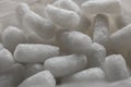 Plastic protective foam background and texture. Macro view of white packing foam background. Bubbly plastic protective granules. Royalty Free Stock Photo