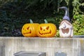 Plastic pumpkins and a scary Halloween mask are standing near the house