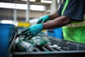 in plastic recycling plant close up worker hands in gloves sort and process city plastic waste.