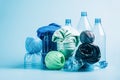 Empty plastic bottle and various fabrics made of recycled polyester fiber synthetic fabric on a blue background Royalty Free Stock Photo