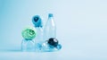 Plastic recycling and reuse concept. Empty plastic bottle and polyester fiber synthetic thread on a blue background. Royalty Free Stock Photo