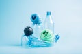 Plastic recycling and reuse concept. Empty plastic bottle and polyester fiber synthetic thread on a blue background. Royalty Free Stock Photo