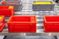 Plastic red box on roller line for tranfer production part in prodine lin in factory, production, transportation concept Royalty Free Stock Photo