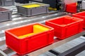 Plastic red box on roller line for tranfer production part in prodine lin in factory, production, transportation concept Royalty Free Stock Photo