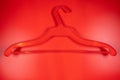 Plastic red coathanger on a red background,top view Royalty Free Stock Photo