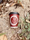 plastic red cup with smile on the ground Royalty Free Stock Photo