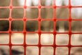 Plastic red mesh close up, background out of focus Royalty Free Stock Photo