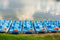 Plastic rental pedal boats parked on the lake shore on a sunny day. Active rest outdoors. Nobody Royalty Free Stock Photo