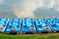 Plastic rental pedal boats parked on the lake shore on a sunny day. Active rest outdoors. Nobody Royalty Free Stock Photo