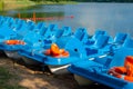 Plastic rental pedal boats parked on the lake shore on a sunny day. Active rest outdoors. Nobody Royalty Free Stock Photo