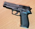 Plastic replica of a handgun on a wooden surface