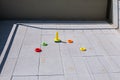 Plastic rings and cone toys making a turn on a pavement balcony