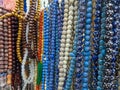 Plastic rosary market view. Colorful plastic rosaries close up shot in the market. Religious beads with colorful strings. Royalty Free Stock Photo