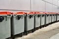 Plastic rubbish bins against gray wall Royalty Free Stock Photo
