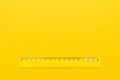 Yellow plastic ruler on the yellow background Royalty Free Stock Photo