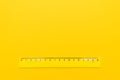 Yellow plastic ruler on the yellow background Royalty Free Stock Photo