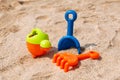 Plastic scoop, rake and watering can for playing on the beach Royalty Free Stock Photo