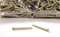 A bag of twisted gold colour nails used for many securing projects-close up