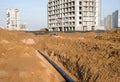 Plastic sewer pipe in trench for laying an external sewage system at a construction site. Sanitary drainage system for a multi- Royalty Free Stock Photo