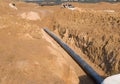 Plastic sewer pipe in trench for laying an external sewage system at a construction site. Sanitary drainage system for a multi- Royalty Free Stock Photo