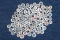 Plastic shiny buttons for clothes on a fabric background. Fashion and clothing. Factory industry Royalty Free Stock Photo